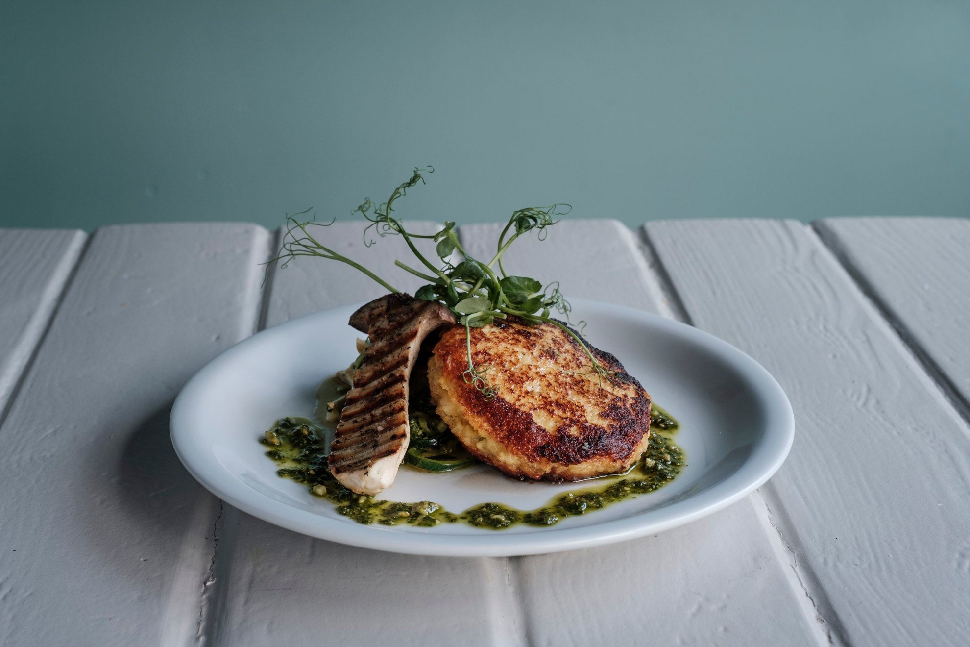 Stuffed couscous cake with courgette linguine, pesto and grilled cep